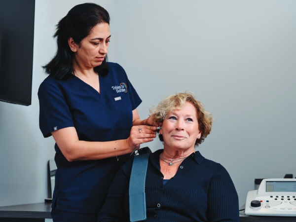 Audiologist checking patients right ear