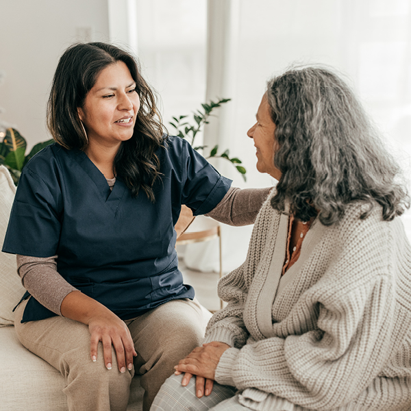Hearing care provider speaking with an older woman during a personalized consultation about hearing loss and cognitive health.