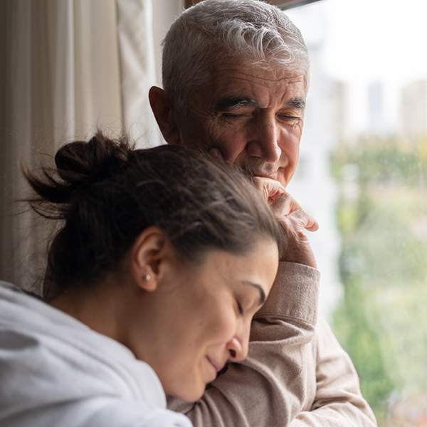 Couple sitting together by a window, representing emotional connection and the role of sensory health in maintaining relationships and cognitive well-being