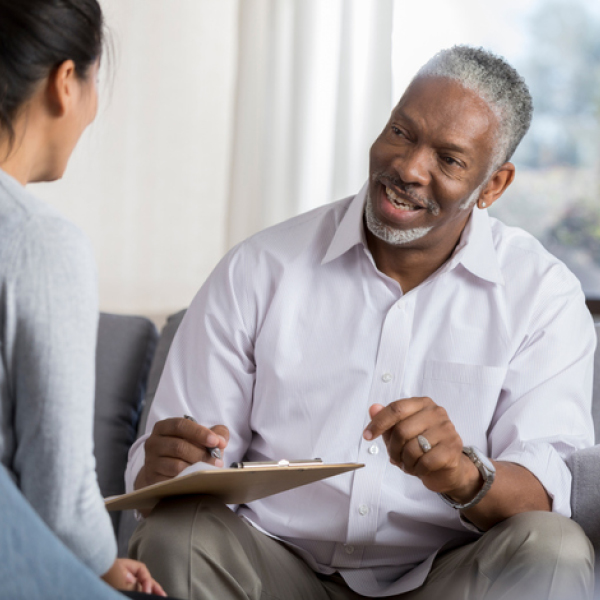A man goes over his hearing results with this audiologist